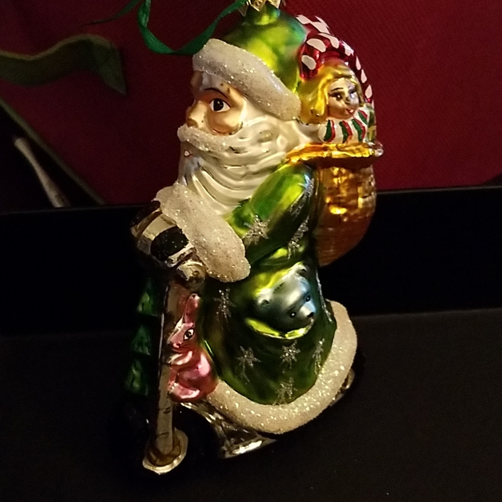 Radko Ornament Santa Claus on a Scooter Green Coat Christmas